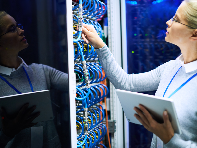 Woman adjusting server cables